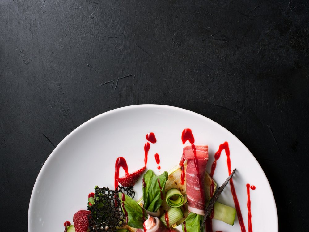 A plated dish set down on a dark table